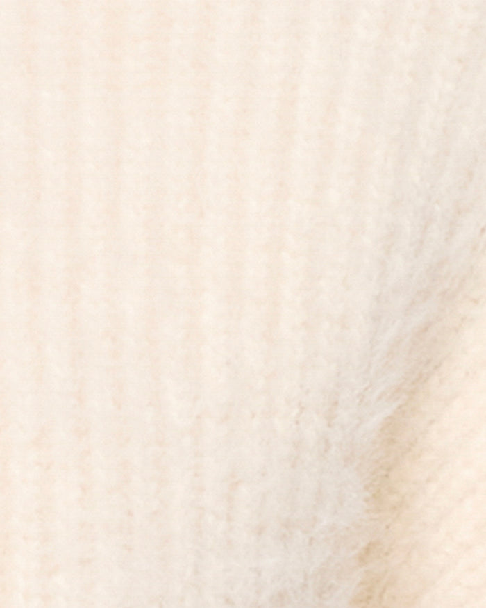 Close-up fabric swatch of the LSPACE Cosmos Sweater in tapioca, showcasing the soft, fuzzy knit texture in a warm cream color.