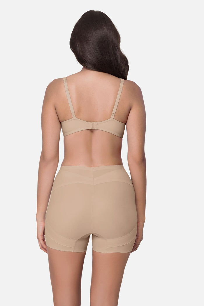 Woman turned away wearing a beige boy short shapewear pant
