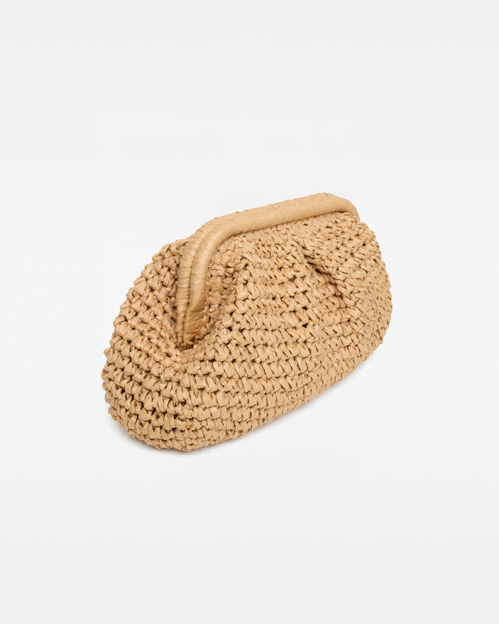 Angled side view of the Harmony Bag in natural as a clutch showing the crochet texture and frame clasp closure, on a white background.