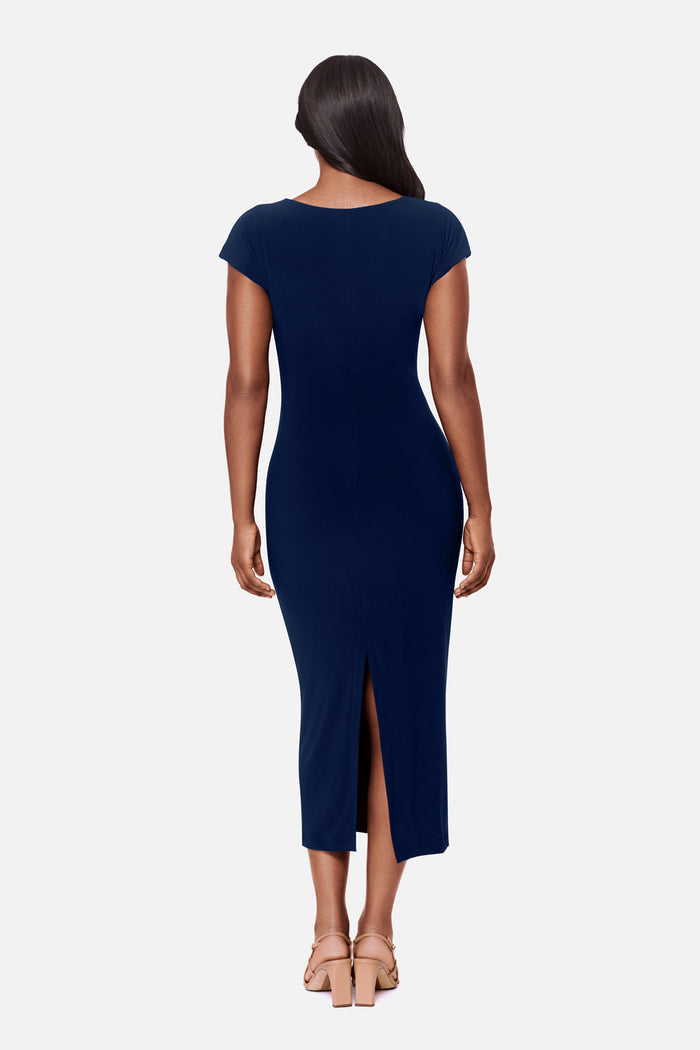 Woman turned away wearing a navy-blue short sleeve dress with a gold tone hardware detail on the side