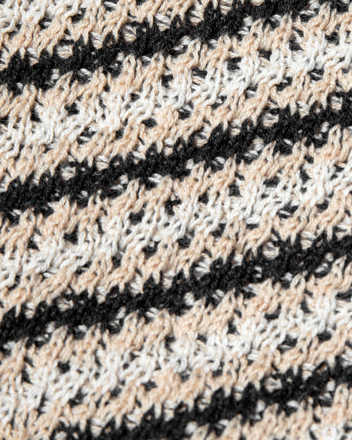 Close-up of the LSPACE La Bianca Top in tip the scales stripe, highlighting the open-weave crochet texture with diagonal black and cream stripe pattern.