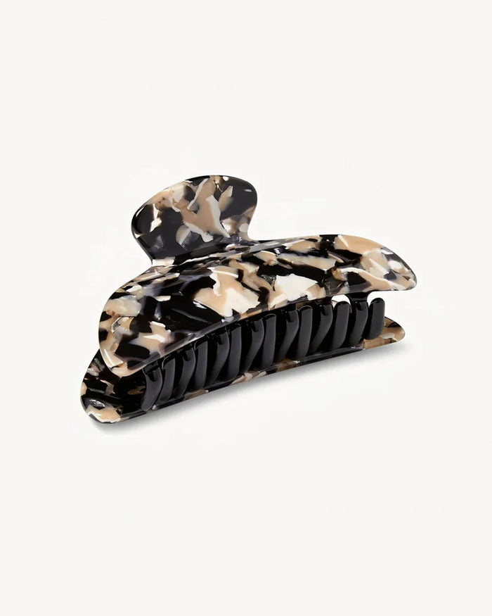 Side view of the Machete Midi Claw in abalone showing the black and cream marble pattern, teeth, and clip mechanism.