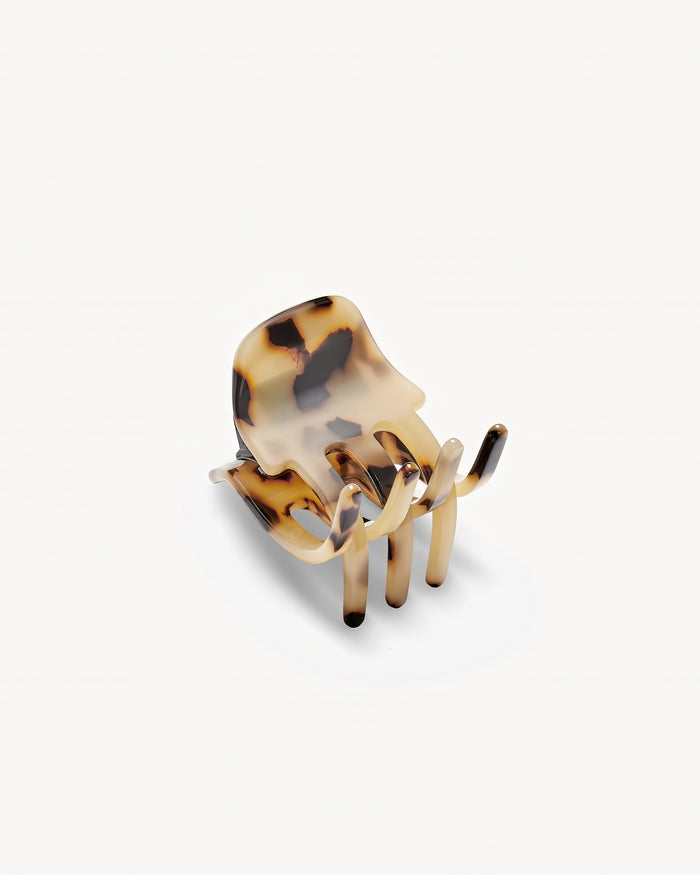 Off-model angled top-down view of the Machete Mini Claw in blonde tortoise showing the front of the claw.