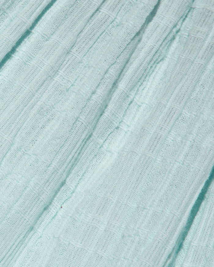 Close-up of the LSPACE Mallorca Dress in ibiza blue, highlighting the lightweight crinkle-gauze fabric texture with subtle woven texture.