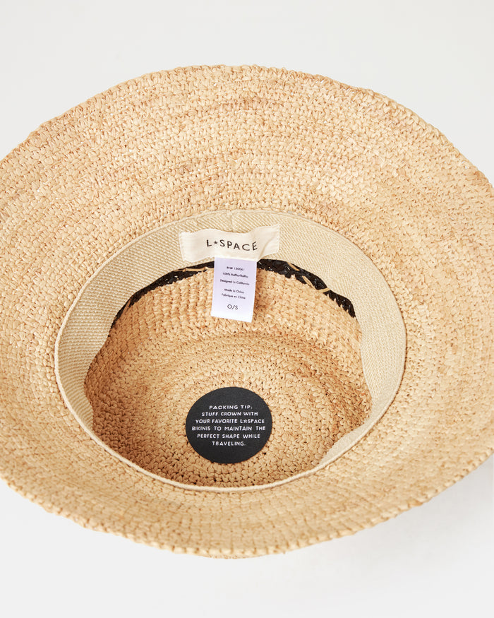 Top-down interior view of the Montauk Bucket Hat in natural showing the LSPACE branding label and packing tip tag.