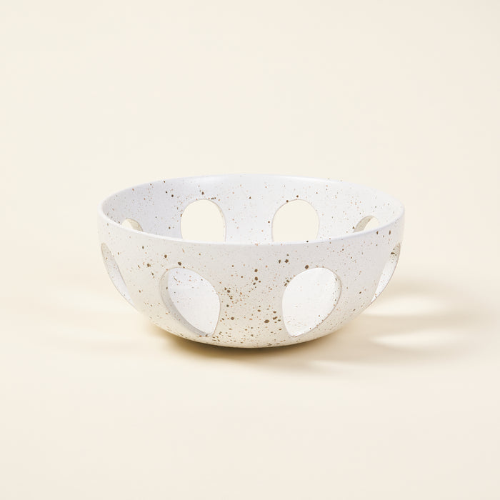 White ceramic orchard bowl with a speckled glazed finish and tear-drop openings.