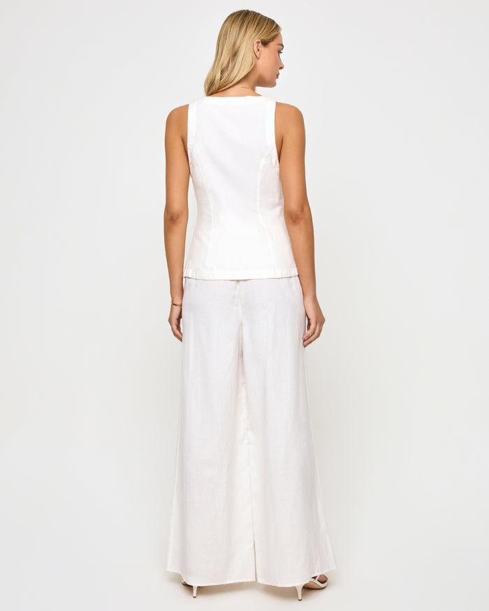 Back view of a model wearing the LSPACE white Palma Pant, high-rise wide-leg trousers with a relaxed fit, styled with a matching white sleeveless top on a neutral studio background.