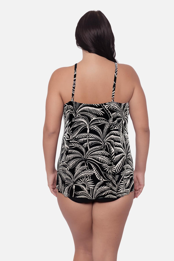 Woman turned away wearing a palm tree printed swim dress