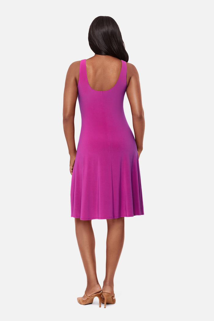 Woman wearing a pink dress with scoopback neckline