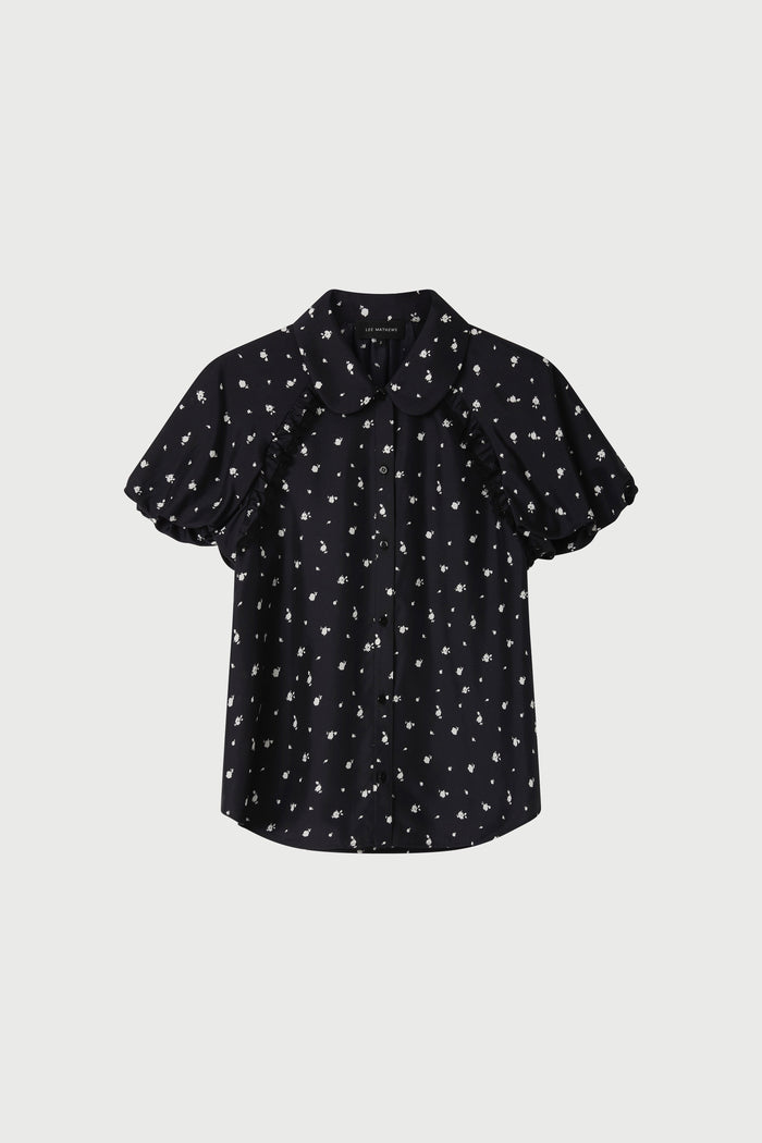Black blouse with white pattern on a light gray background
