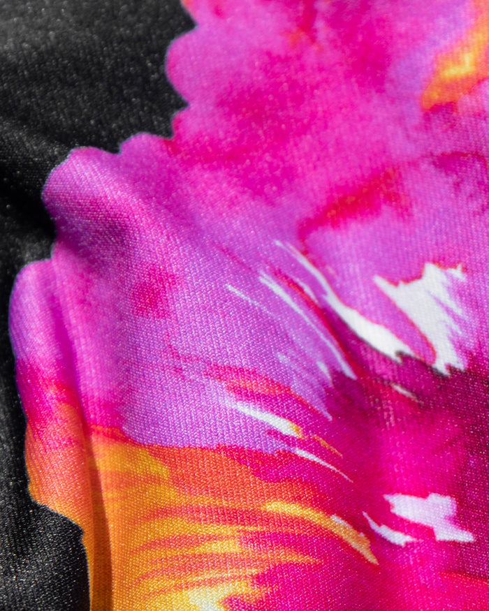 Close-up detail of the LSPACE after midnight hibiscus print showing vibrant pink, purple, orange, and white hibiscus flowers on a dark background.