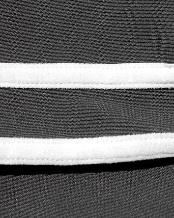 Close-up detail view of the LSPACE Sutton Pant in black-cream, highlighting the cream side stripe.