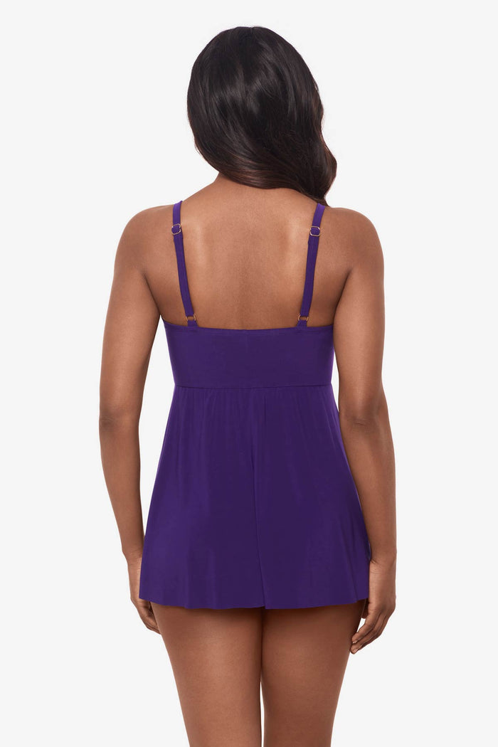 Woman looking away wearing a mulberry purple swim dress