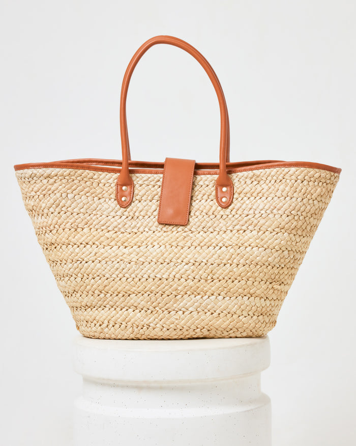 Front view of the Alfie Bag in natural on a white pedestal.