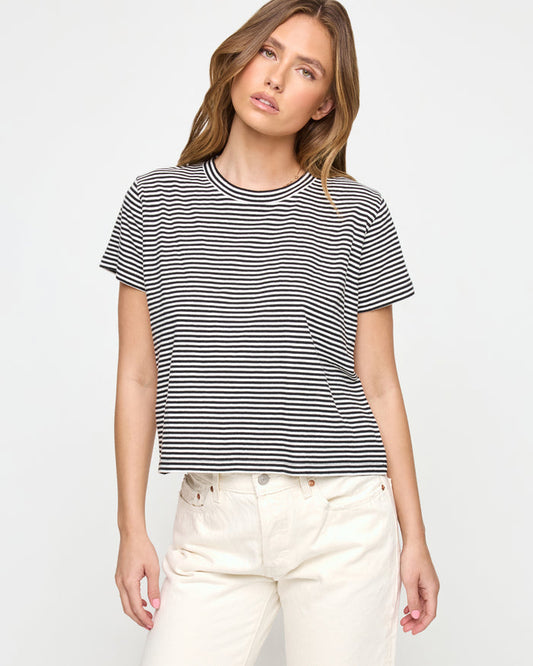 Front view of a model wearing the LSPACE All Day Top in black-cream, a relaxed cropped boxy t-shirt with black and cream horizontal stripes, crew neckline, and short sleeves.