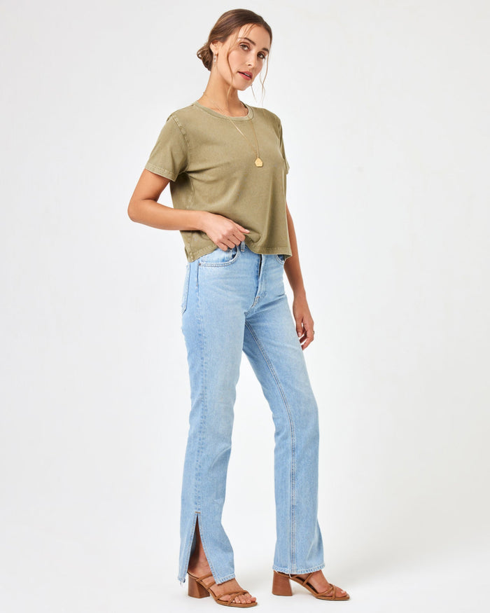 Side view of a model wearing the LSPACE All Day Top in olive branch, styled with light wash jeans.