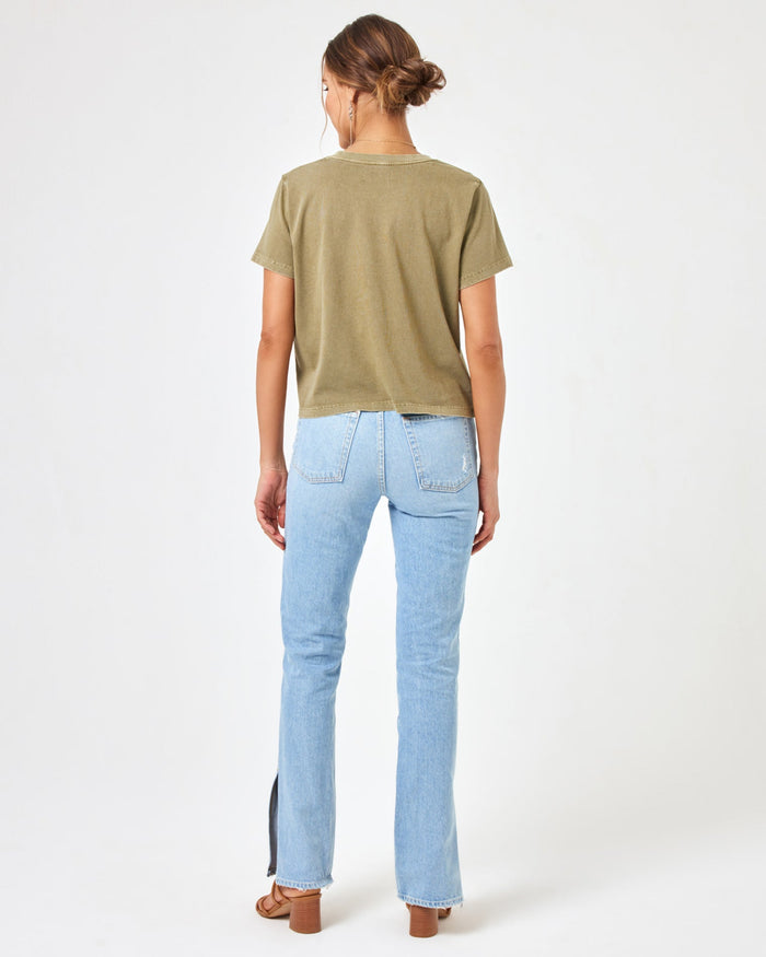 Back view of a model wearing the LSPACE All Day Top in olive branch, styled with light wash jeans.