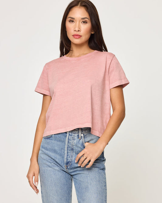 Front view of a model wearing the LSPACE All Day Top in pink clay, a relaxed cropped boxy t-shirt with a crew neckline and short sleeves.