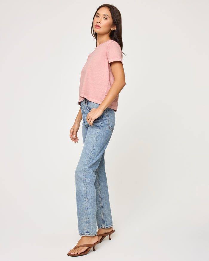Side view of a model wearing the LSPACE All Day Top in pink clay, highlighting the relaxed cropped fit and short sleeves.
