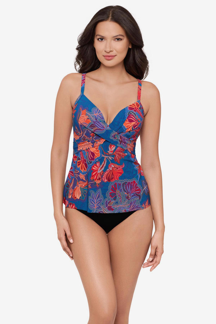 Woman wearing a red and orange flower printed tankini top