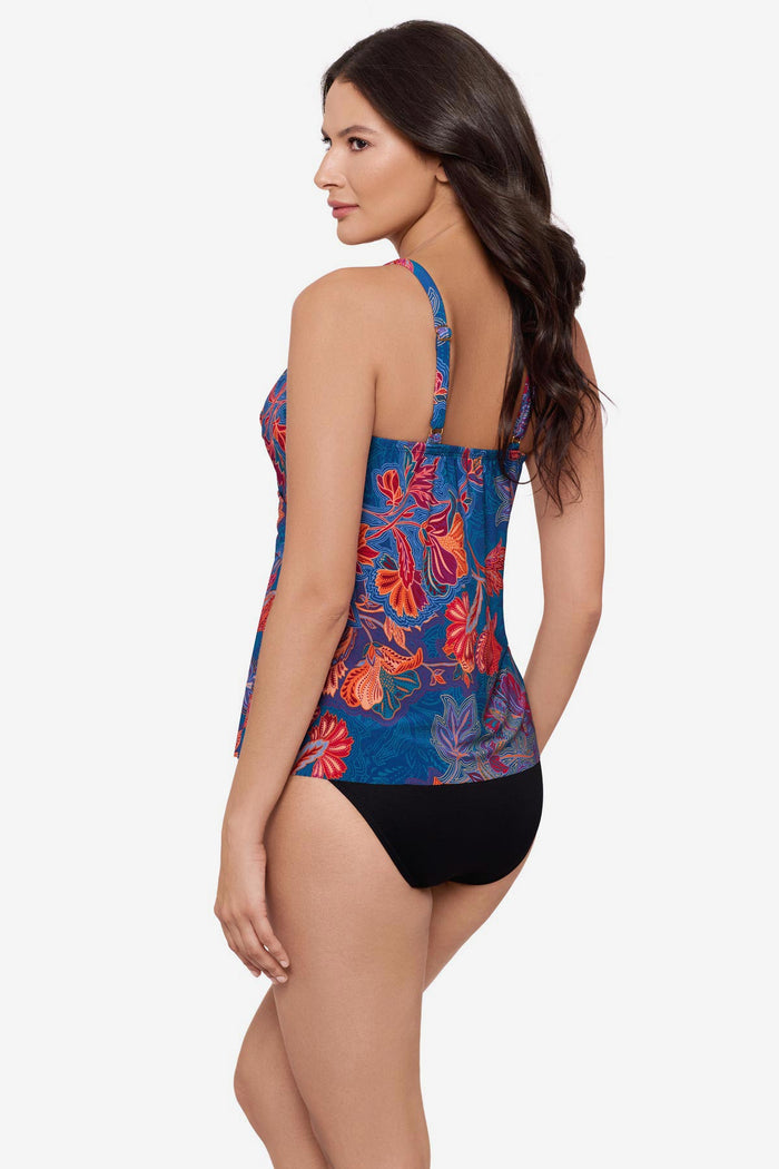 Woman turned left wearing a red and orange flower printed tankini top