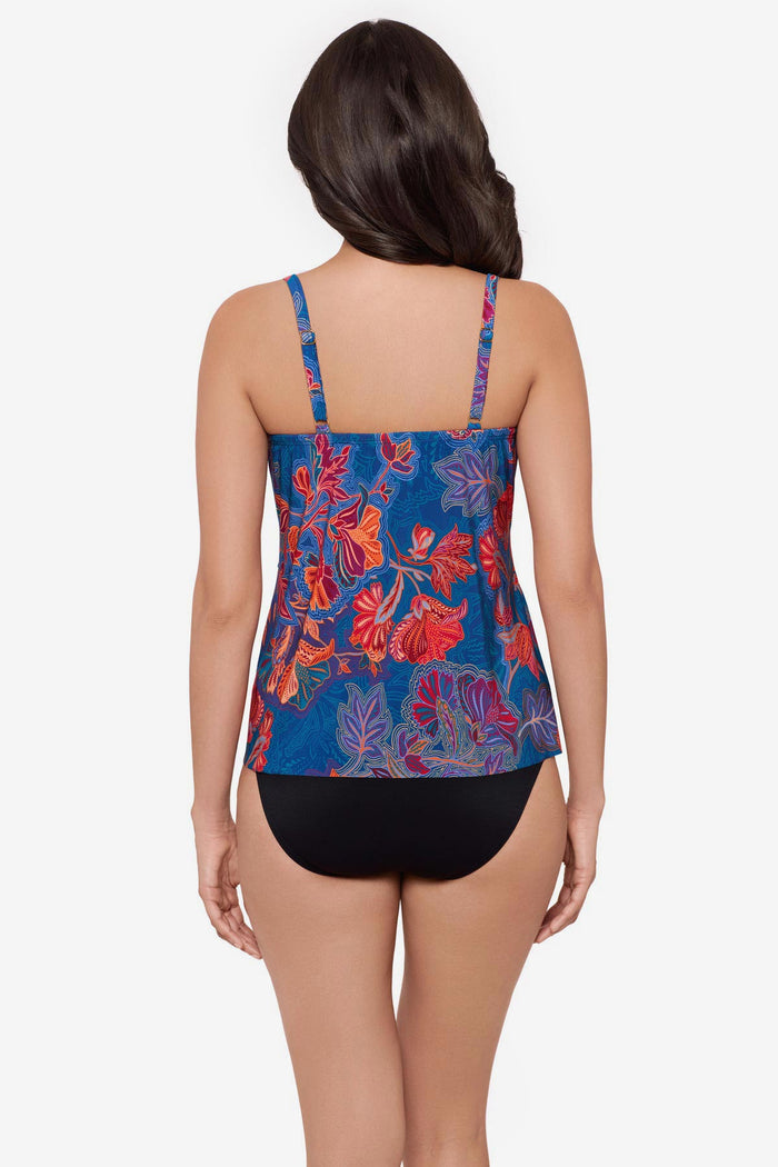 Woman turned away wearing a red and orange flower printed tankini top