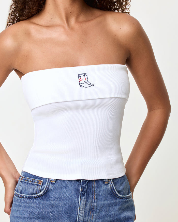 Close-up of the LSPACE Andie Top in yallspace, highlighting the embroidered cowboy boot graphic on the white ribbed strapless tube top with fold-over edge detail.