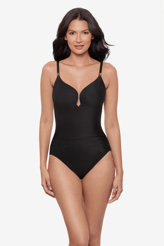 Woman wearing a black one-piece swimsuit with a sweetheart neckline