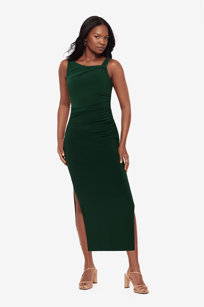 Woman wearing a dark green maxi dress with slits on both sides