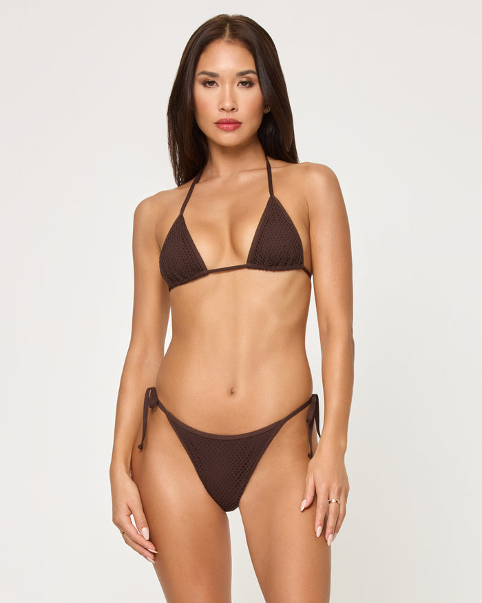Front view of a model wearing the LSPACE espresso Aspen Bikini Top, a textured triangle halter style with adjustable neck ties, paired with a matching espresso textured Levy Bikini Bottom with side-tie closure.