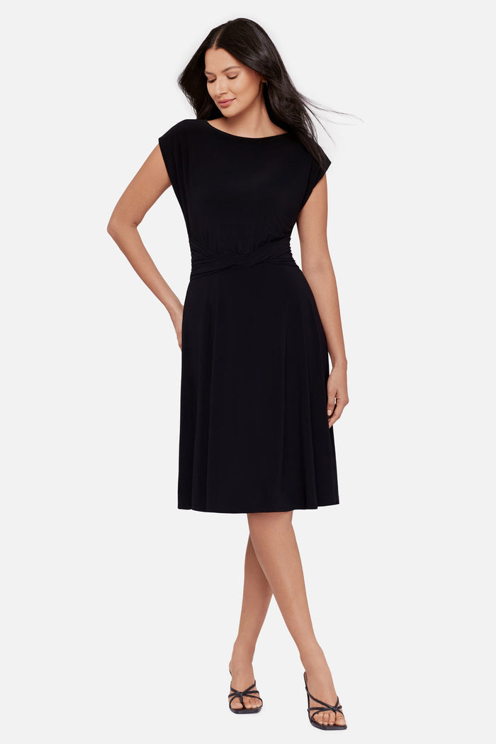 Woman wearing a black short sleeve mid length dress