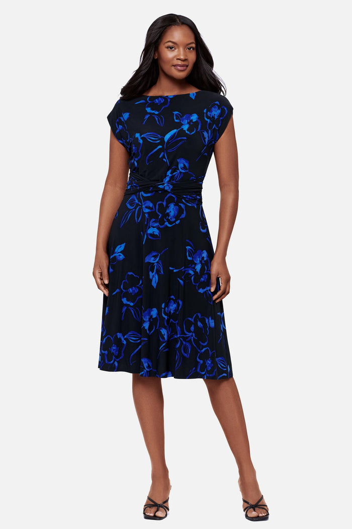 Woman wearing a black and blue floral printed short sleeve mid length dress