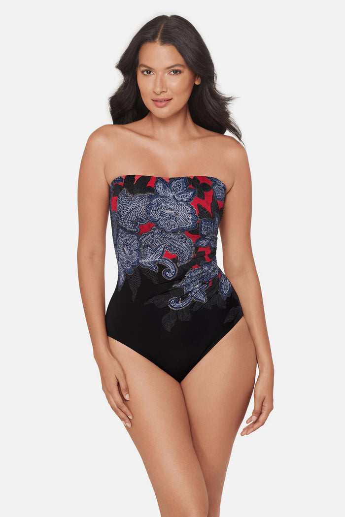Woman wearing a multicolored abstract floral printed bandeau one-piece swimsuit