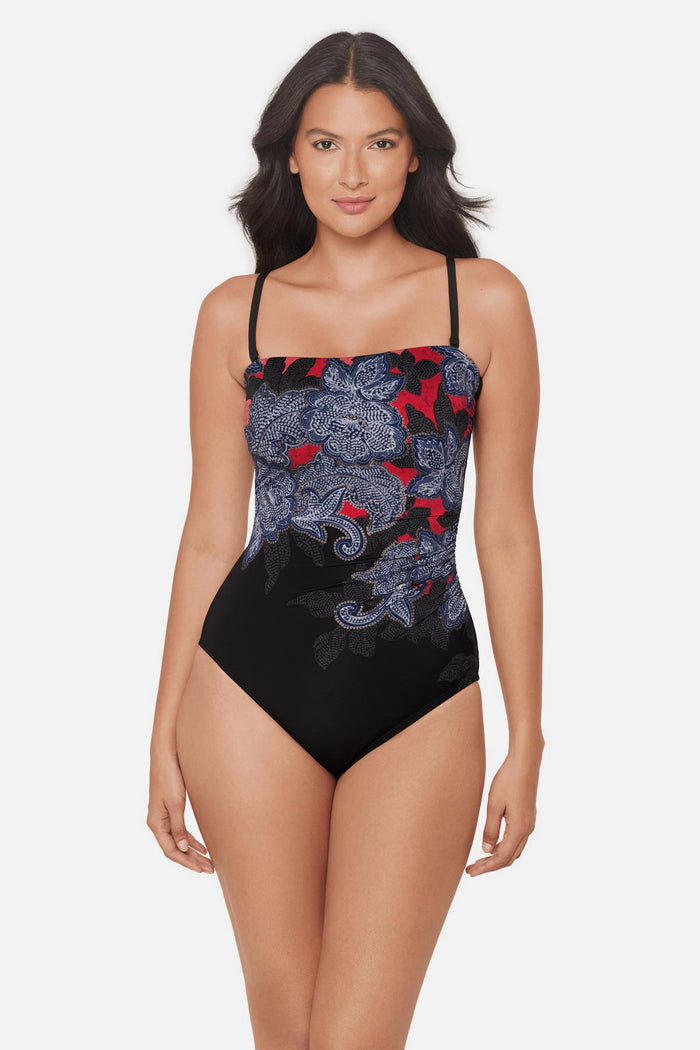 Woman wearing a multicolored abstract floral printed bandeau one-piece swimsuit