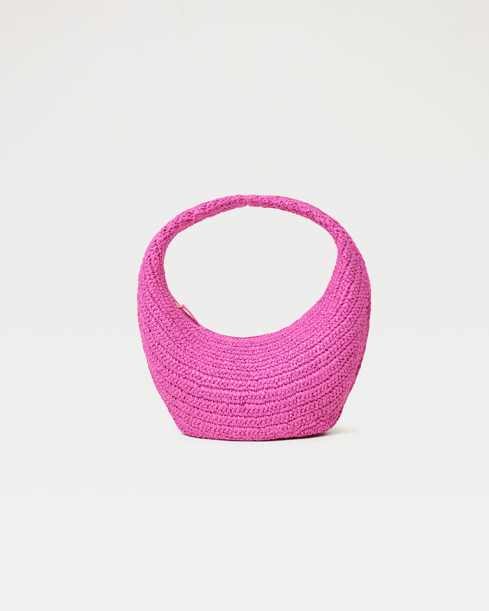 Front view of the Aya Bag in bubblegum pink, a crescent-shaped woven raffia hobo bag, on a white background.