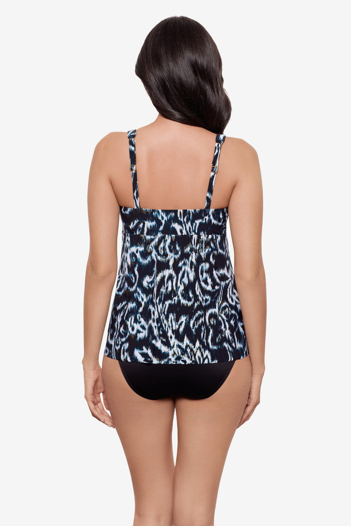Woman turned away wearing a black and white abstract printed tankini top