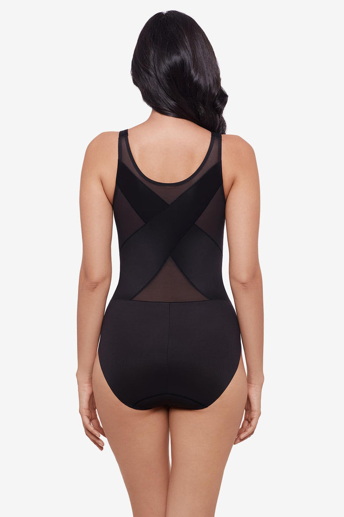 Woman faced away wearing black one-piece shapewear