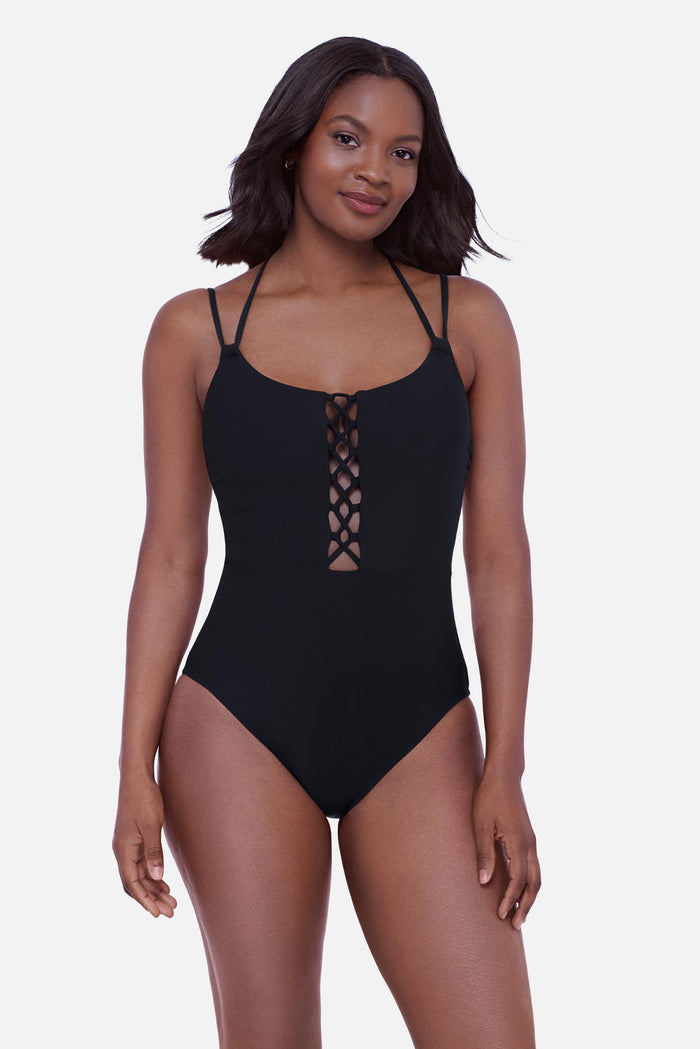 Woman wearing a black one-piece swimsuit with double straps and a lattice front
