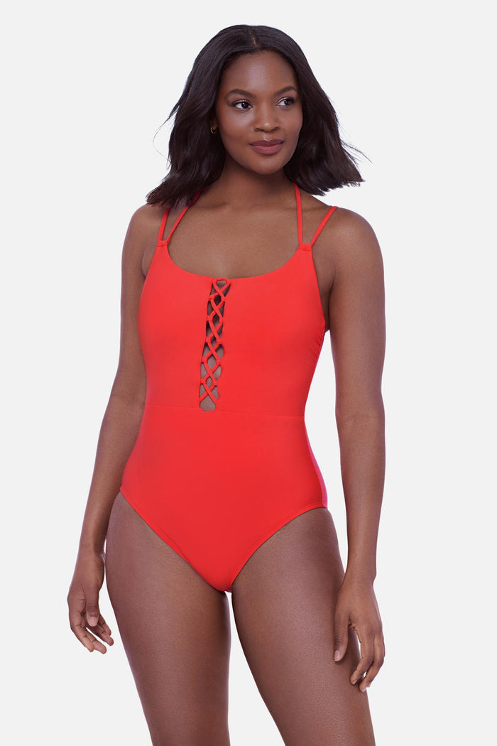 Woman wearing an orange one-piece swimsuit with double straps and lattice front