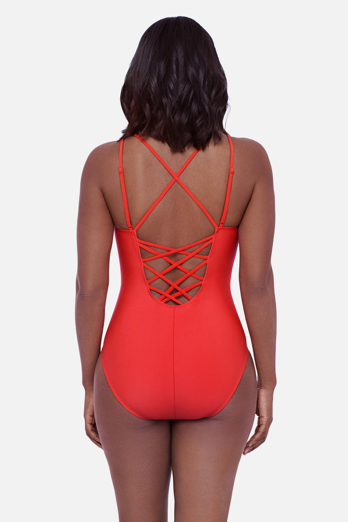 Woman faced away wearing an orange one-piece swimsuit with double straps and lattice back