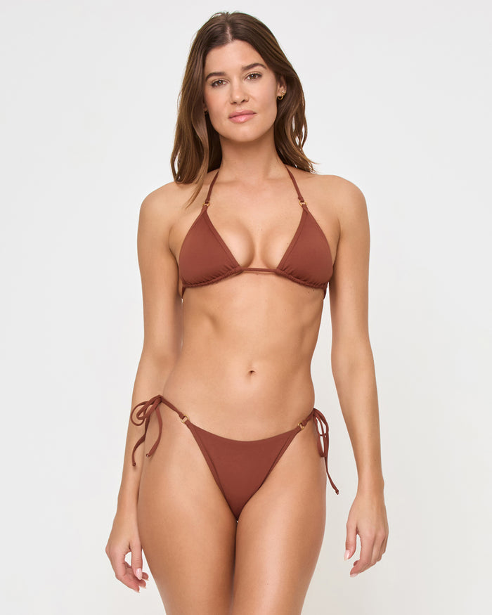 Front view of a model wearing the tobacco LSPACE Banning Bikini Bottom with side ties in a studio setting, paired with a matching tobacco Banning Bikini Top.