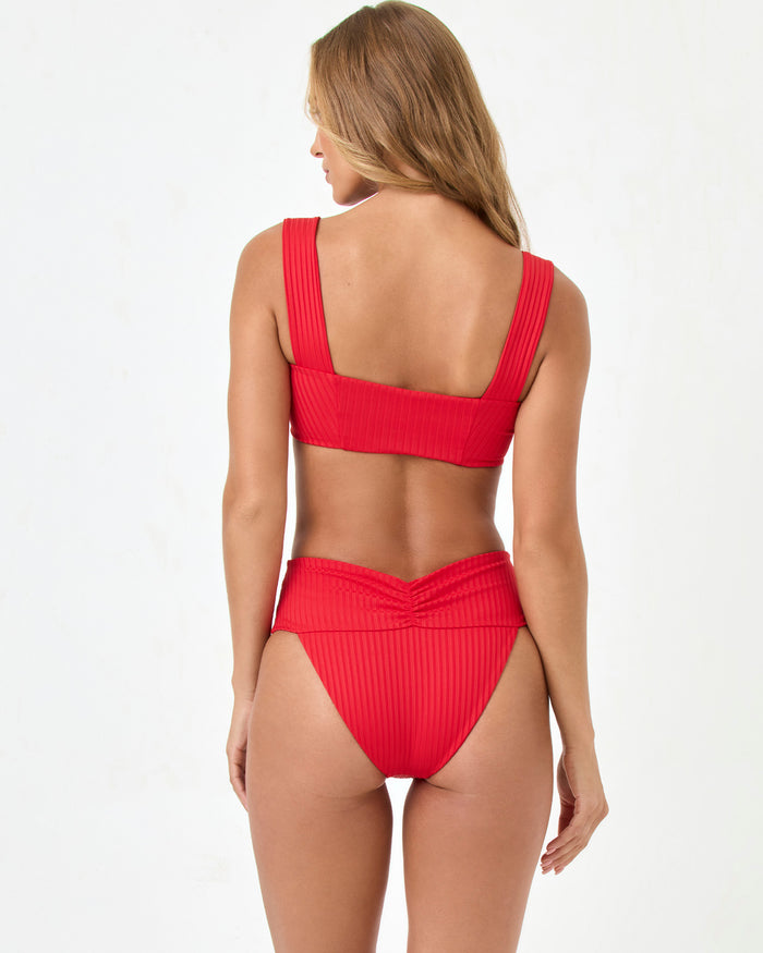 Back view of a model wearing the LSPACE flame Bardot Bikini Bottom with a matching ribbed Marlee Bikini Top.