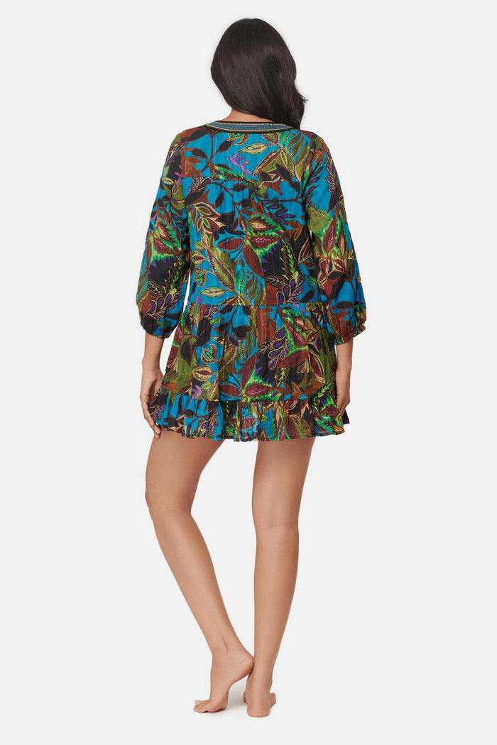 Woman turned away wearing a multicolored abstract paisley printed beach dress swim cover up