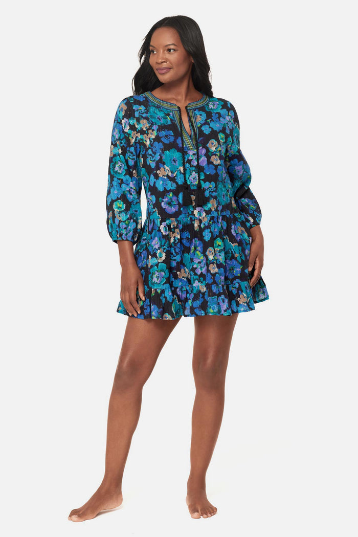 Woman wearing a black and blue floral printed swim cover up dress