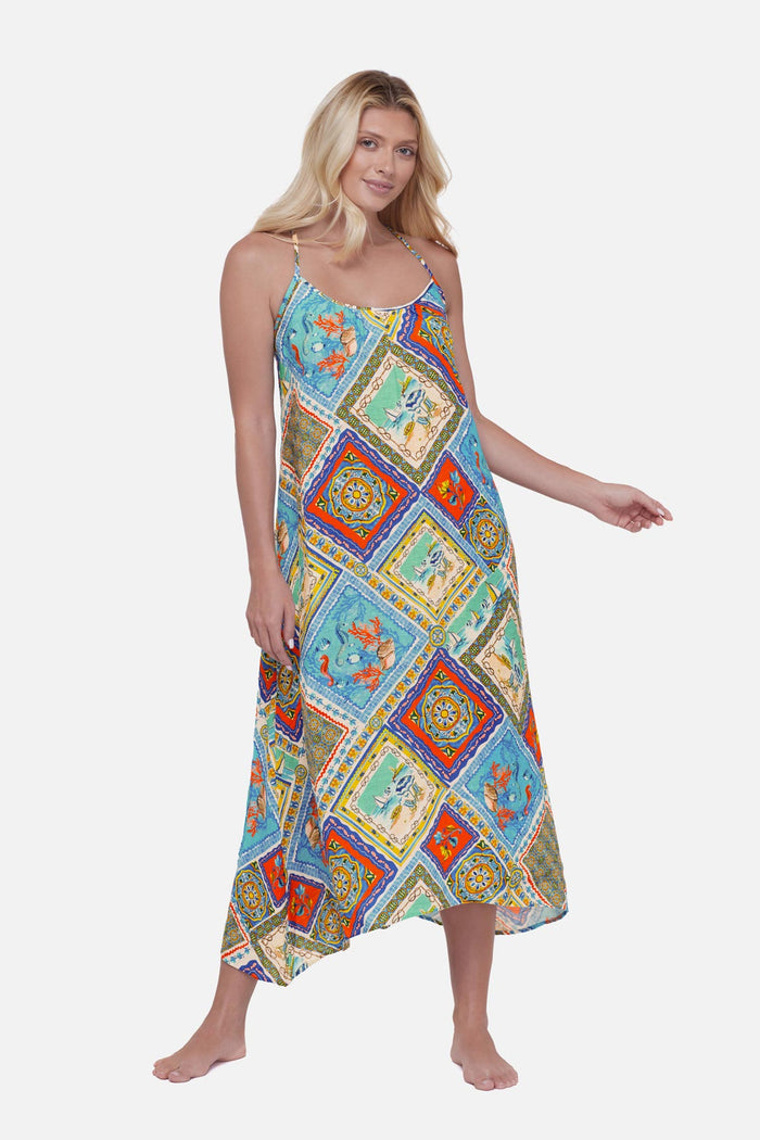 Woman wearing a printed swim cover up with detailed artwork in each tile
