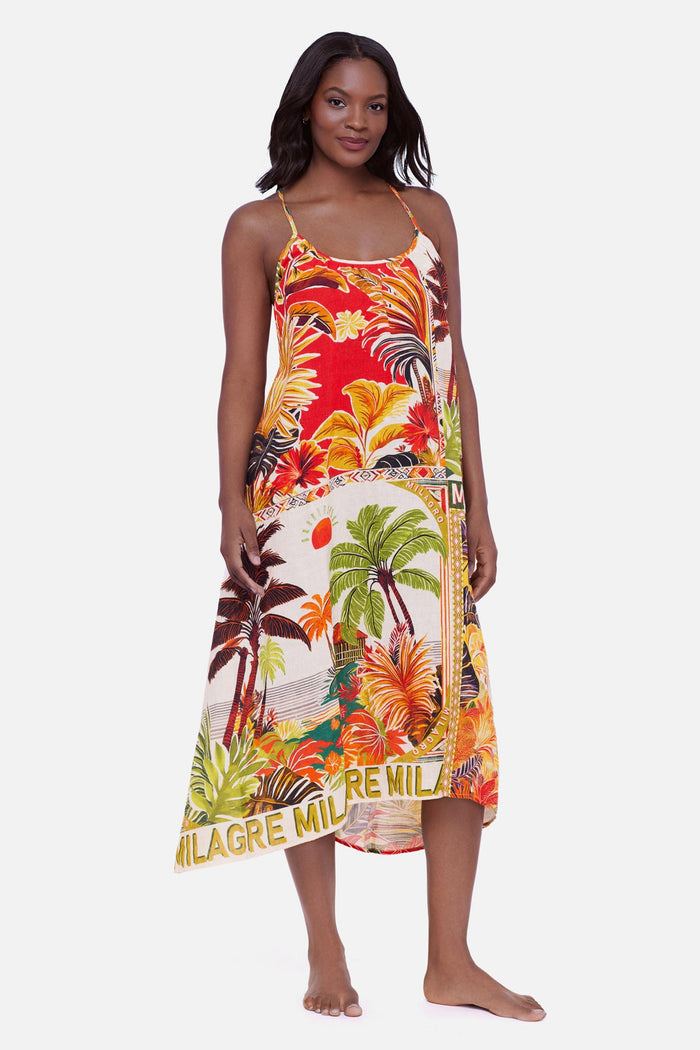 Woman wearing a multicolored tropical scene printed swim cover up