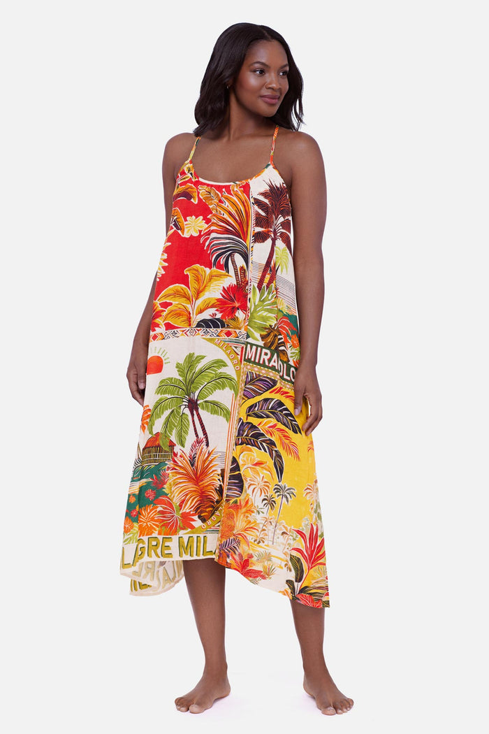 Woman wearing a multicolored tropical scene printed swim cover up