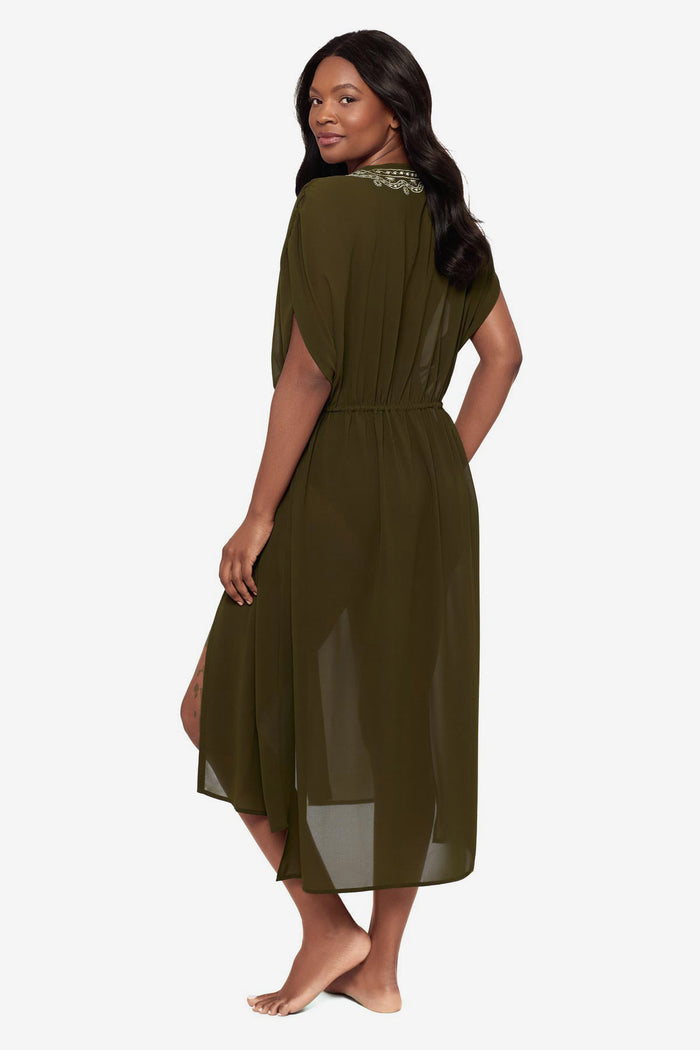 Woman turned left wearing a green kimono swim cover up