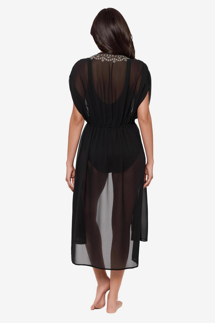 Woman turned away wearing a black kimono swim cover up