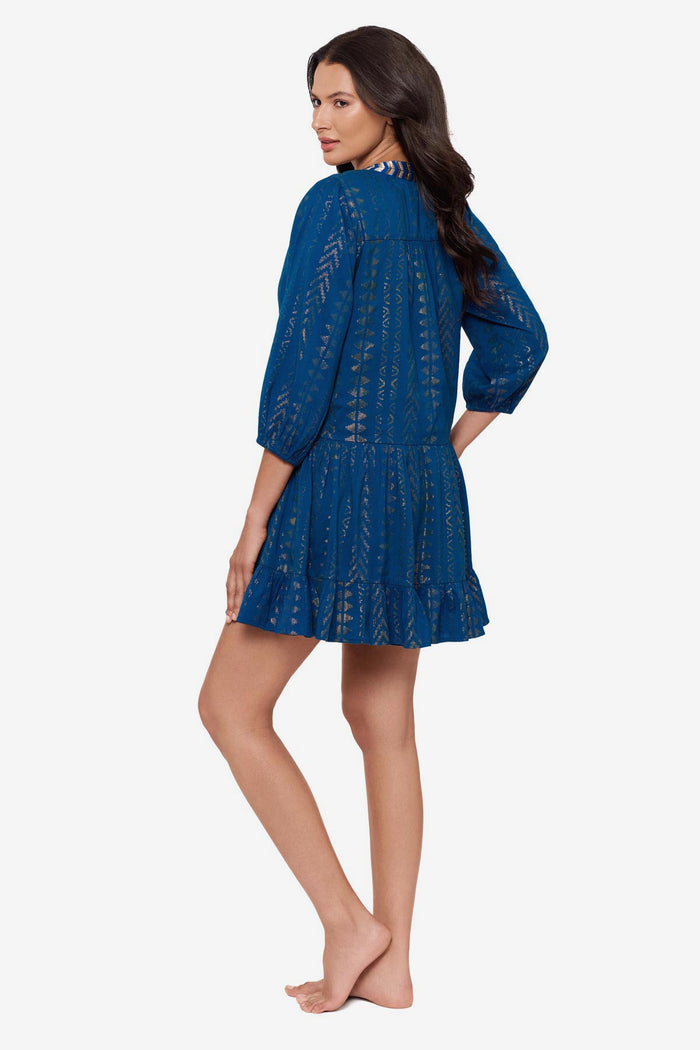 Woman turned left wearing a blue pull-over kimono swim dress